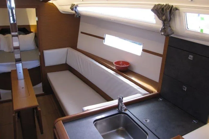 Naia Grey Yacht Photos Pics Interior of 2022 Jeanneau Sun Odyssey 349 yacht with modern kitchen and seating area.