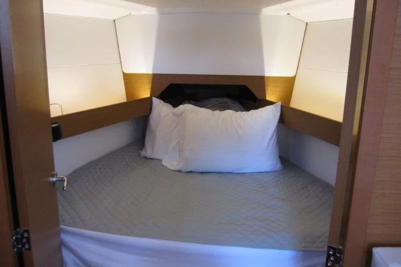 Naia Grey Yacht Photos Pics Cozy cabin interior of 2022 Jeanneau Sun Odyssey 349 sailboat with comfortable bedding.
