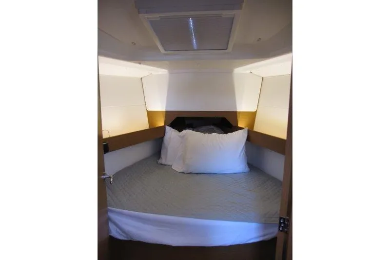 Naia Grey Yacht Photos Pics Cozy cabin interior of 2022 Jeanneau Sun Odyssey 349 sailboat with bed and pillows.