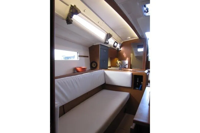 Naia Grey Yacht Photos Pics Interior of 2022 Jeanneau Sun Odyssey 349 sailboat, featuring cozy seating and modern design.