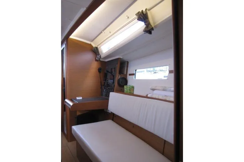 Naia Grey Yacht Photos Pics Interior of 2022 Jeanneau Sun Odyssey 349 sailboat, featuring seating and navigation area.