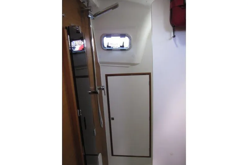 Naia Grey Yacht Photos Pics Interior of 2022 Jeanneau Sun Odyssey 349 sailboat, featuring a compact bathroom with shower.