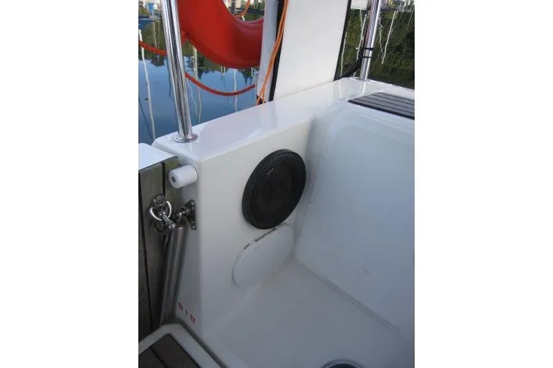 Naia Grey Yacht Photos Pics Cockpit area of 2022 Jeanneau Sun Odyssey 349 sailboat with speaker and safety equipment.