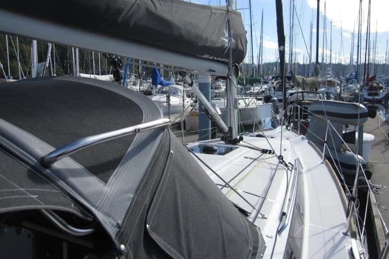 Naia Grey Yacht Photos Pics Jeanneau Sun Odyssey 349 sailboat, 2022 model, docked in a marina with other boats.
