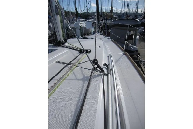 Naia Grey Yacht Photos Pics 2022 Jeanneau Sun Odyssey 349 sailboat deck with rigging and marina background.