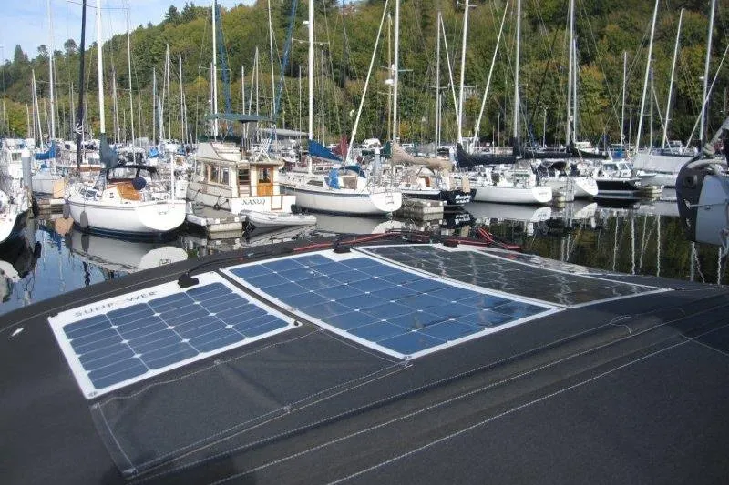 Naia Grey Yacht Photos Pics Jeanneau Sun Odyssey 349 sailboat with solar panels docked in a marina, 2022 model.