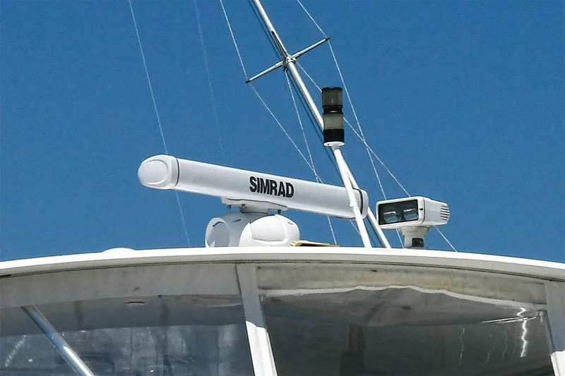 Salty Dog Yacht Photos Pics Radar equipment on a 2002 Viking 48 Convertible boat against a clear blue sky.
