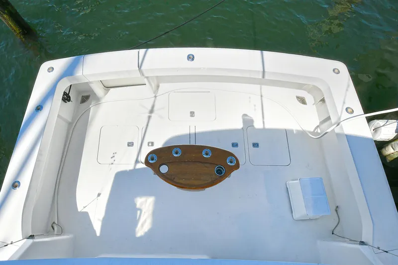 Salty Dog Yacht Photos Pics Viking 48 Convertible 2002 boat deck with fishing rod holders, docked on water.