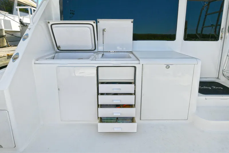 Salty Dog Yacht Photos Pics Outdoor kitchen area on a 2002 Viking 48 Convertible yacht with storage drawers.