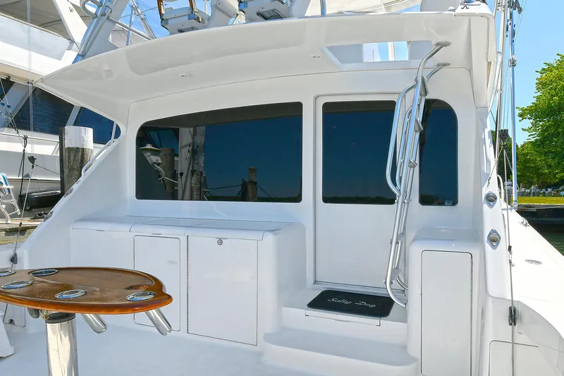 Salty Dog Yacht Photos Pics 2002 Viking 48 Convertible yacht deck with seating and fishing rod holders.