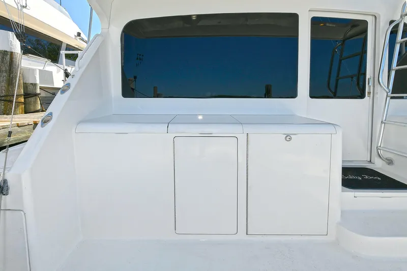 Salty Dog Yacht Photos Pics 2002 Viking 48 Convertible yacht with sleek white exterior and spacious deck area.