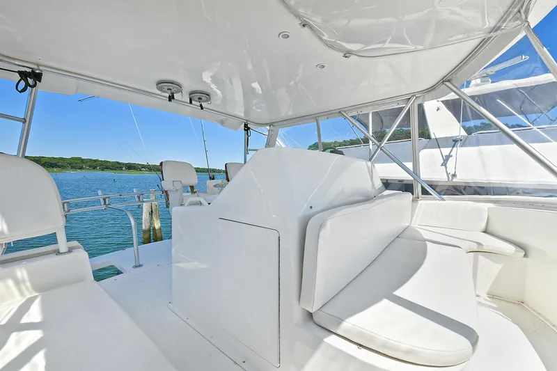 Salty Dog Yacht Photos Pics 2002 Viking 48 Convertible yacht interior with white seating and ocean view.