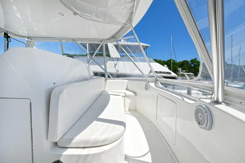 Salty Dog Yacht Photos Pics 2002 Viking 48 Convertible yacht interior with white seating and clear windows.