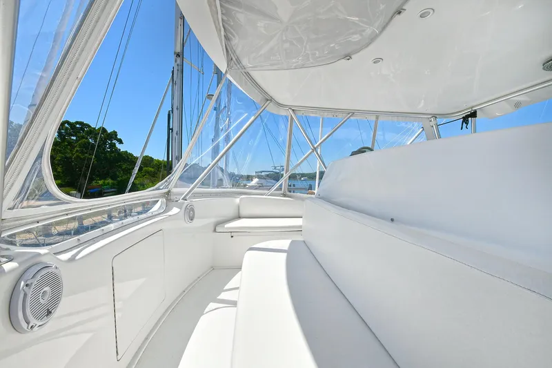 Salty Dog Yacht Photos Pics 2002 Viking 48 Convertible yacht interior with white seating and clear windows.