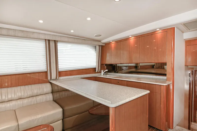 Salty Dog Yacht Photos Pics Interior of 2002 Viking 48 Convertible yacht with modern kitchen and seating area.