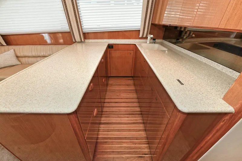 Salty Dog Yacht Photos Pics 2002 Viking 48 Convertible yacht interior with sleek countertops and wooden cabinetry.