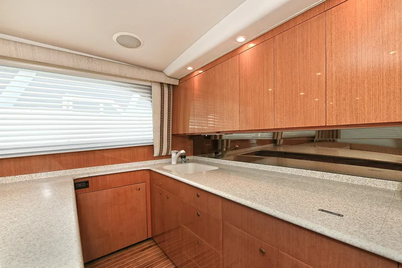 Salty Dog Yacht Photos Pics 2002 Viking 48 Convertible yacht kitchen with wood cabinets and modern countertops.
