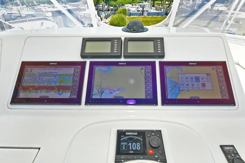 Salty Dog Yacht Photos Pics Control panel of a 2002 Viking 48 Convertible yacht with navigation screens.