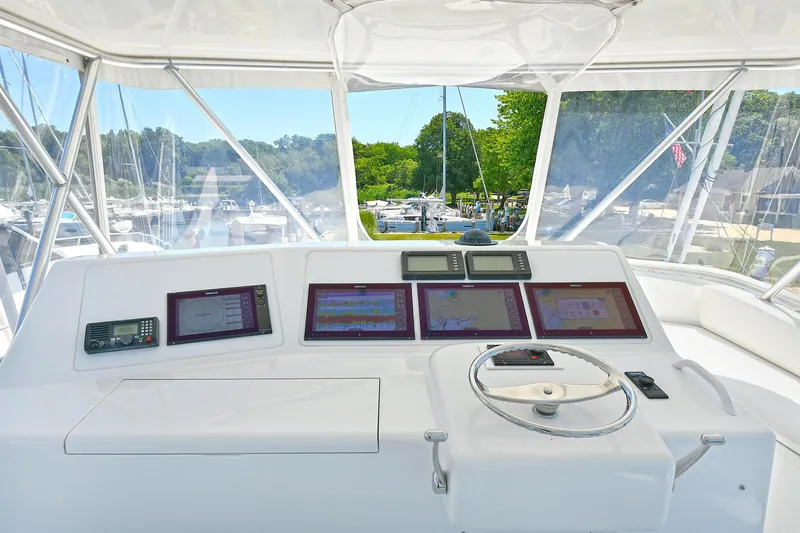 Salty Dog Yacht Photos Pics Helm of 2002 Viking 48 Convertible yacht with navigation screens and steering wheel.
