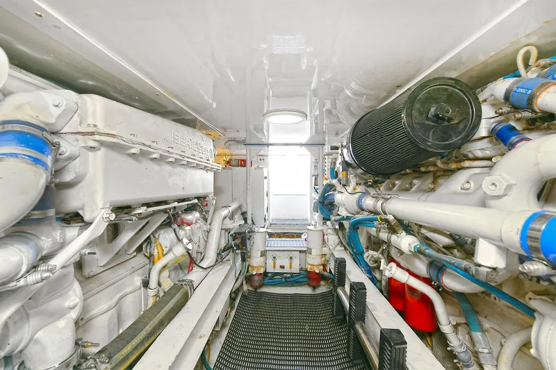 Salty Dog Yacht Photos Pics Engine room of 2002 Viking 48 Convertible yacht, showcasing mechanical components and piping.