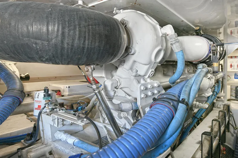 Salty Dog Yacht Photos Pics Engine room of 2002 Viking 48 Convertible yacht with visible hoses and components.