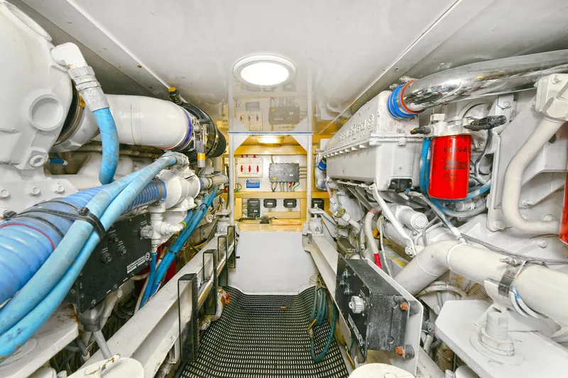Salty Dog Yacht Photos Pics Engine room of a 2002 Viking 48 Convertible yacht, showcasing mechanical components and systems.