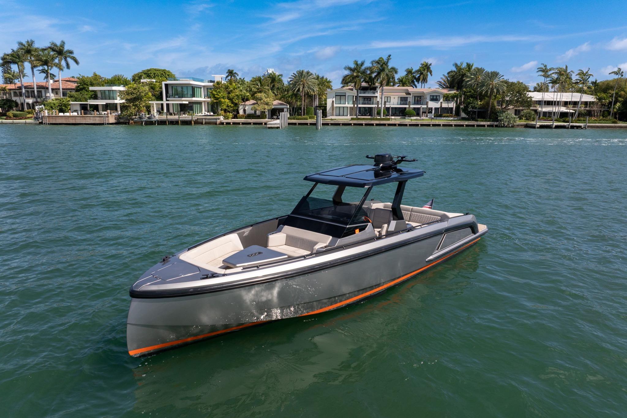2022 Vanquish VQ40 boat on water, luxury waterfront homes in background.