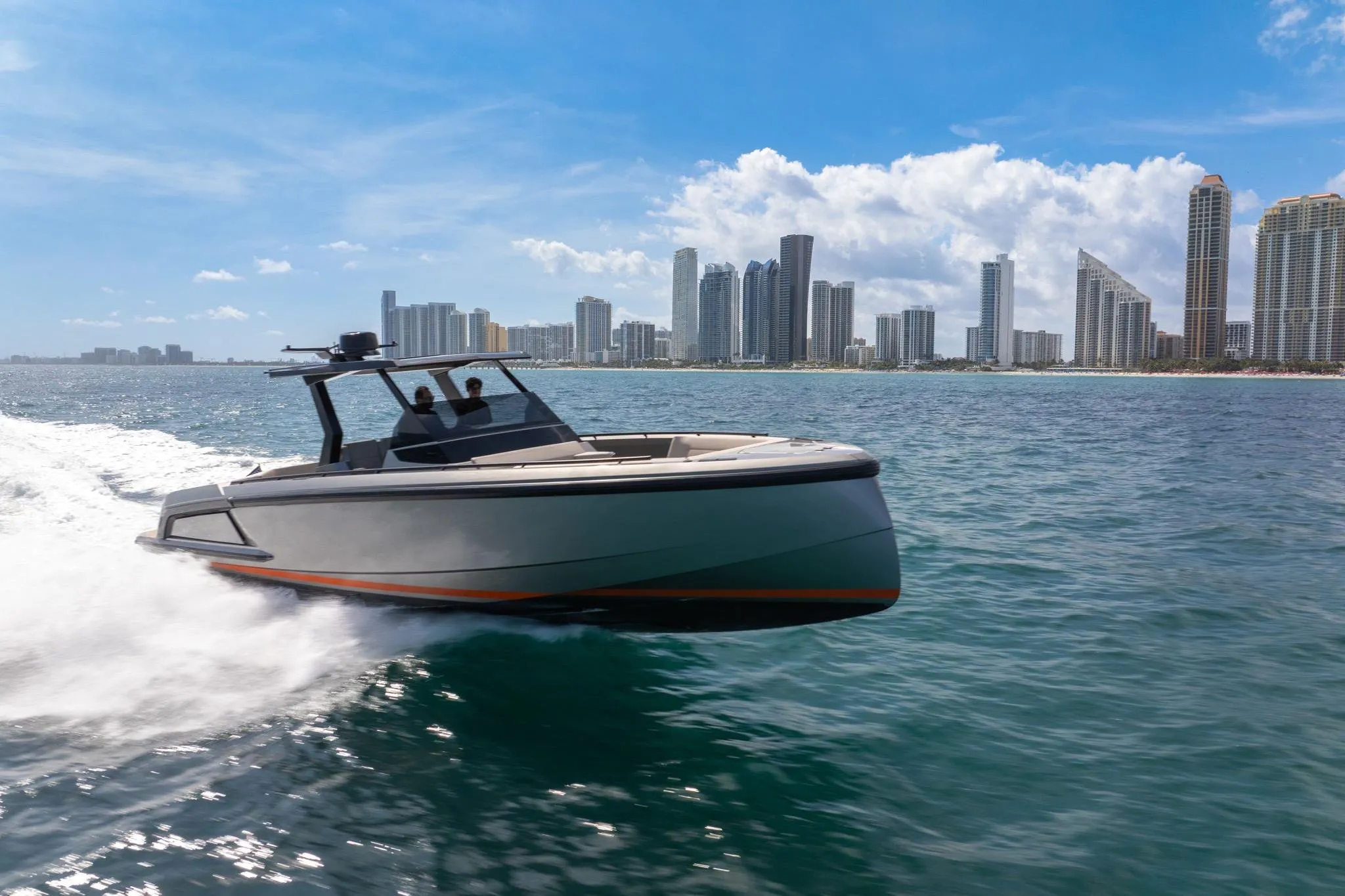 2022 Vanquish VQ40 yacht cruising near city skyline on a sunny day.