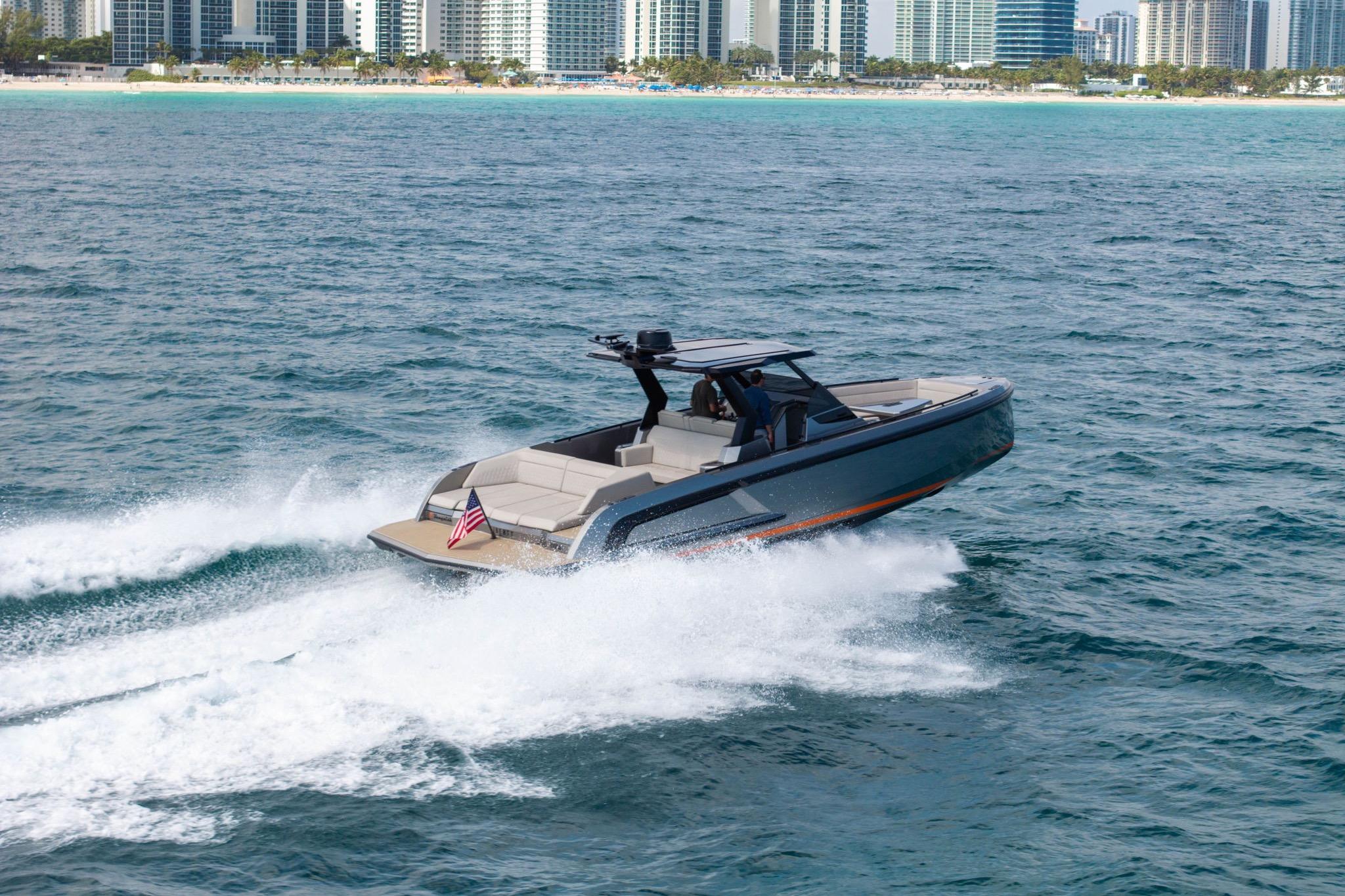 2022 Vanquish VQ40 yacht cruising near a city skyline on open water.