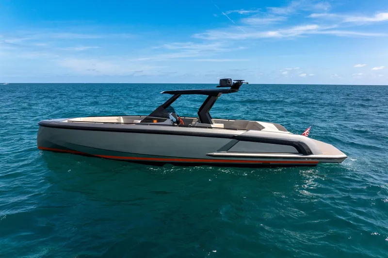 Yacht Photos Pics 2022 Vanquish VQ40 luxury yacht cruising on open sea under clear blue sky.