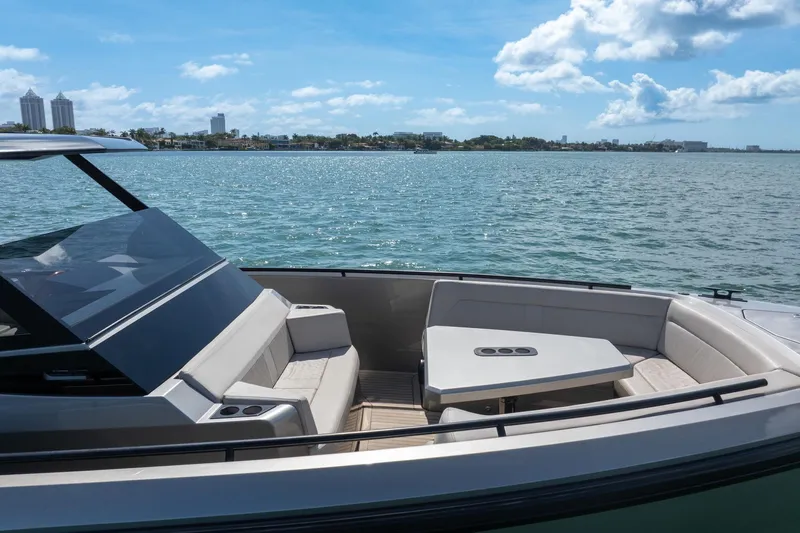  Yacht Photos Pics Luxurious 2022 Vanquish VQ40 yacht with elegant seating, cruising on a sunny day.