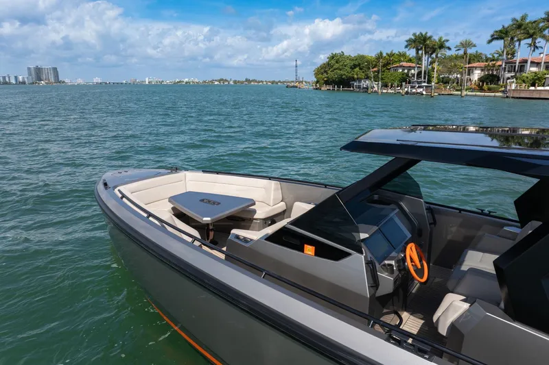  Yacht Photos Pics 2022 Vanquish VQ40 luxury yacht on serene water with modern design and spacious seating.