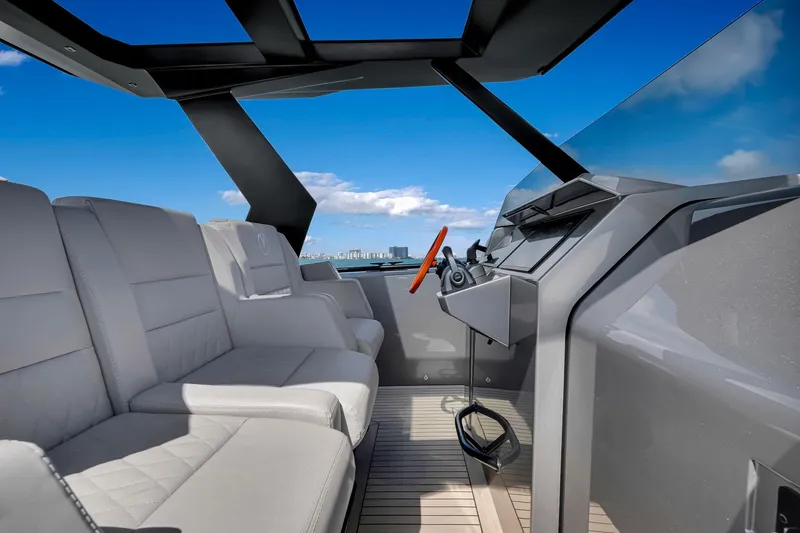  Yacht Photos Pics Luxurious interior of 2022 Vanquish VQ40 yacht with modern seating and steering.