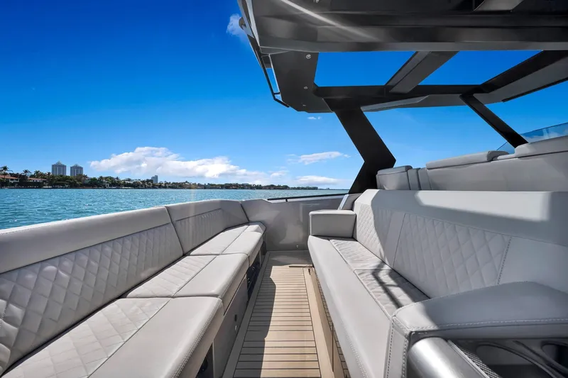  Yacht Photos Pics Luxurious 2022 Vanquish VQ40 yacht interior with elegant seating and scenic ocean view.