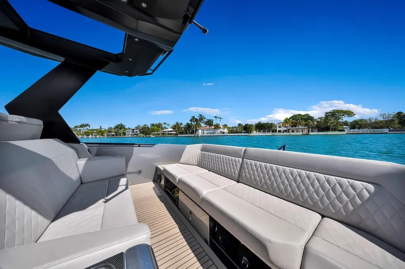  Yacht Photos Pics Luxurious 2022 Vanquish VQ40 yacht interior with elegant seating, overlooking serene waterfront views.