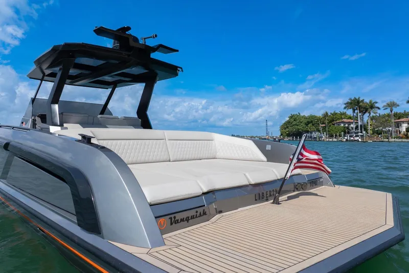  Yacht Photos Pics 2022 Vanquish VQ40 luxury yacht on water, featuring sleek design and American flag.