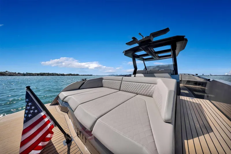  Yacht Photos Pics Luxurious 2022 Vanquish VQ40 yacht with spacious deck and American flag on open water.