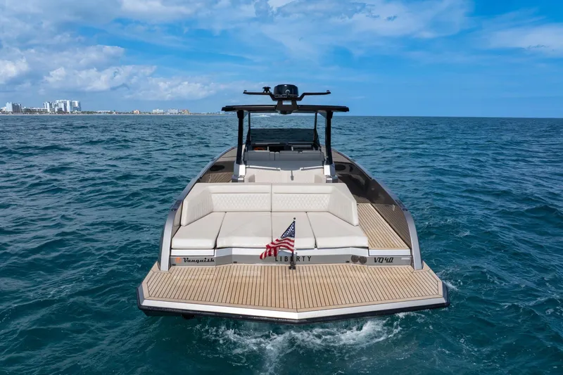 Yacht Photos Pics 2022 Vanquish VQ40 luxury yacht on open sea, rear view with American flag.