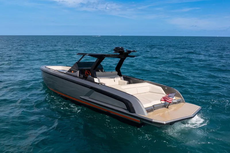  Yacht Photos Pics 2022 Vanquish VQ40 luxury yacht cruising on open sea with American flag.