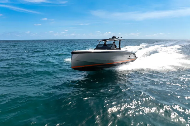  Yacht Photos Pics 2022 Vanquish VQ40 boat cruising on open ocean under clear blue sky.