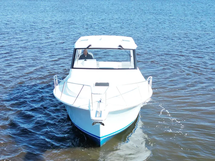  Yacht Photos Pics 2025 Henriques 35 Express Hardtop boat cruising on open water.