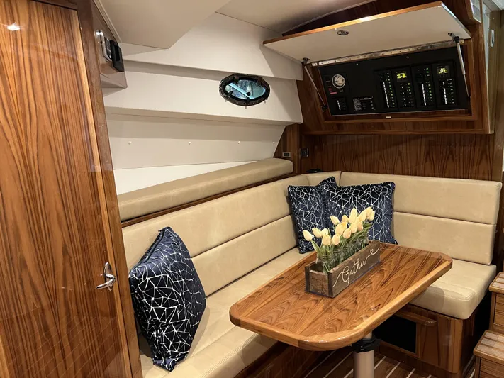  Yacht Photos Pics Interior of 2025 Henriques 35 Express Hardtop with wood finish and cozy seating area.