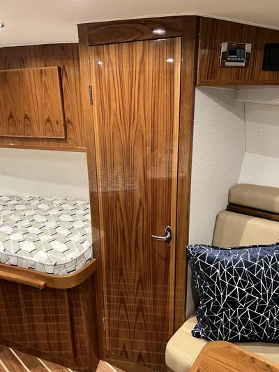  Yacht Photos Pics 2025 Henriques 35 Express Hardtop interior with wood finish and modern furnishings.