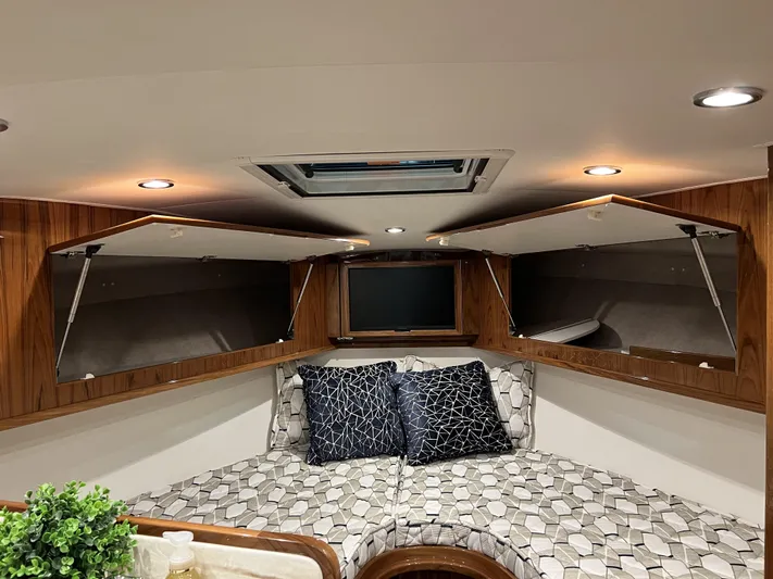  Yacht Photos Pics 2025 Henriques 35 Express Hardtop cabin interior with modern design and geometric-patterned bedding.