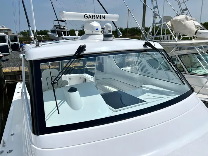  Yacht Photos Pics 2025 Henriques 35 Express Hardtop boat with Garmin radar, docked at marina.