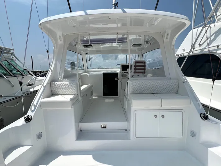  Yacht Photos Pics 2025 Henriques 35 Express Hardtop boat interior with white seating and modern design.