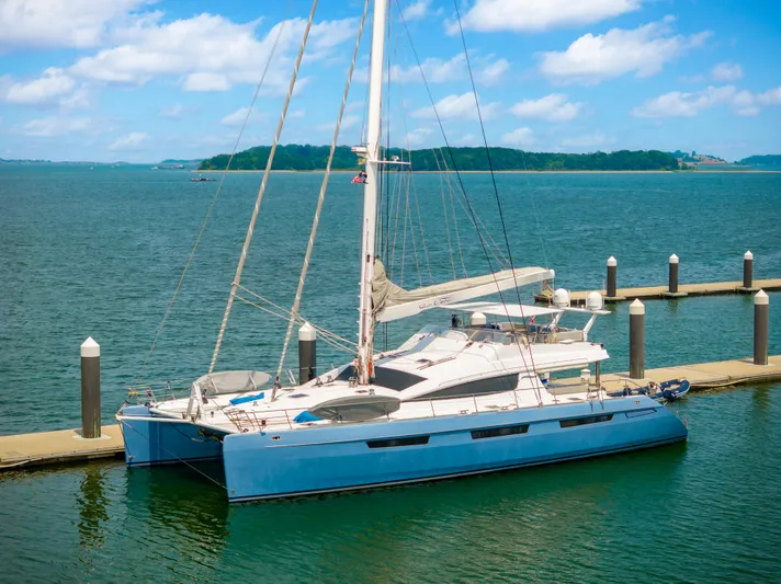 Sur L'eau Yacht Photos Pics Luxury Privilege 745 catamaran docked at marina, 2008 model, under clear blue sky.