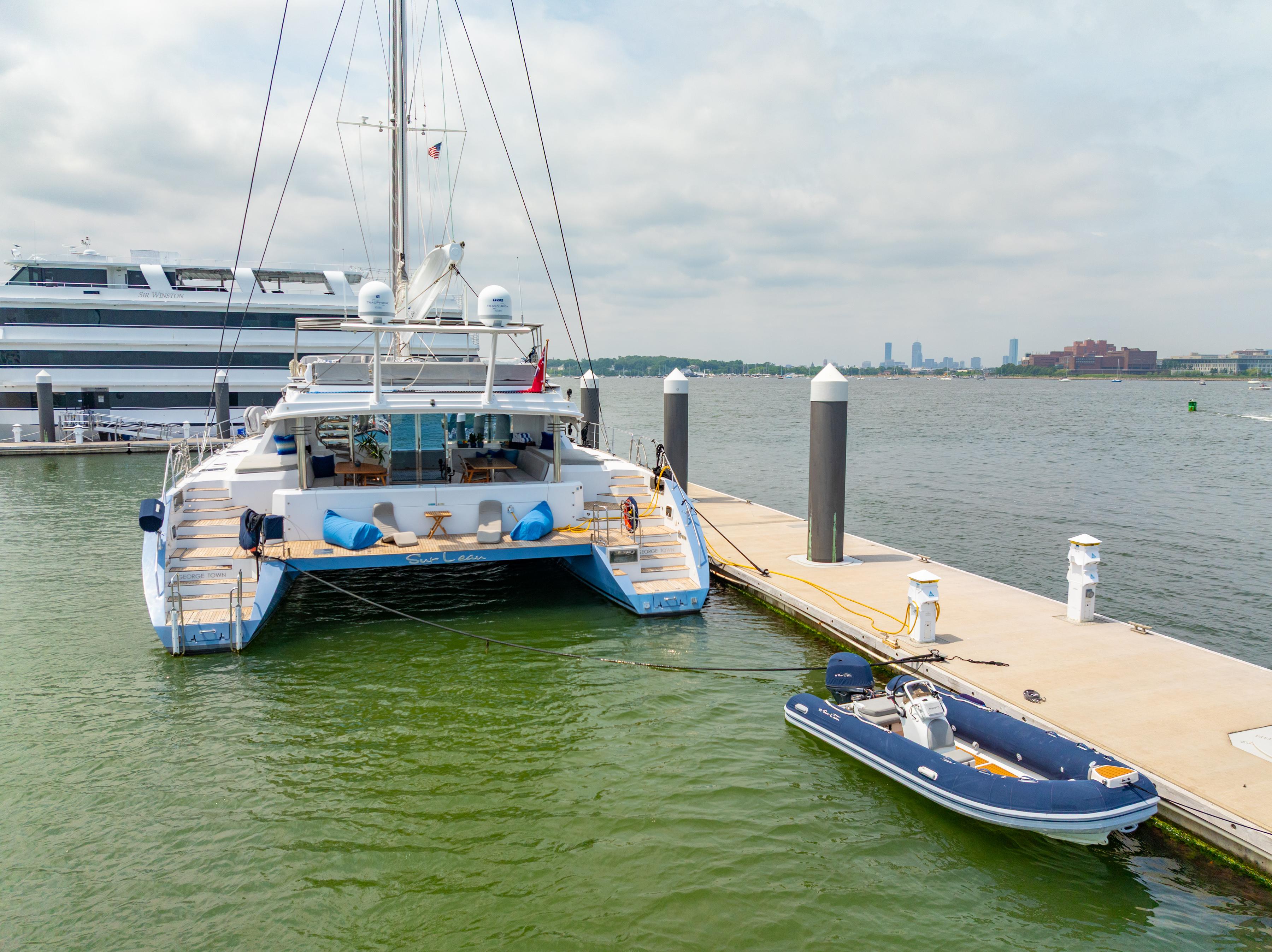 Luxury Privilege 745 yacht docked with inflatable boat, 2008 model, scenic waterfront view.