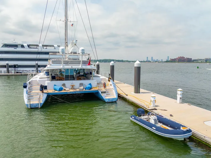 Sur L'eau Yacht Photos Pics Luxury Privilege 745 yacht docked with inflatable boat, 2008 model, scenic waterfront view.