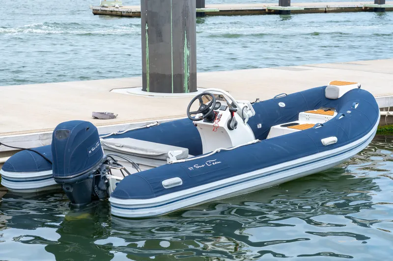 Sur L'eau Yacht Photos Pics Blue Privilege 745 inflatable boat docked, 2008 model, with outboard motor.